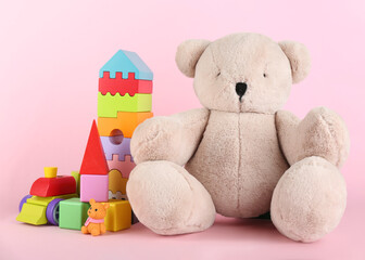 Set of different toys on pink background
