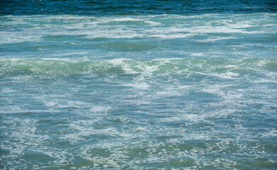 Waves at the seashore. Selective focus with shallow depth of field.