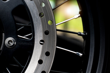 Abstract dark tone beside veiw of Disc Brake of motorcycle.