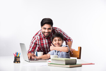 Online school in India concept - Cute little son taking father's help in studies or homework - obrazy, fototapety, plakaty