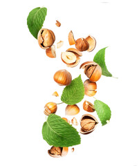 Crushed hazelnuts with leaves on a white background