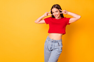 Photo of funny lady showing v-sign symbols near eyes wear casual red top denim isolated yellow color background