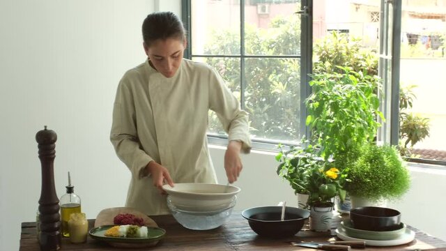Woman cooking steak tartare