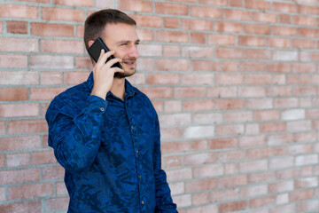 British man with stubble talking with girlfriend at phone