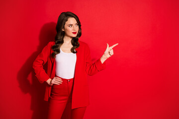 Photo of gorgeous charming classy lady point finger empty space wear shiny pants isolated on red bright color background