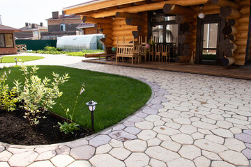 landscape design in a country house with trees and pebbles