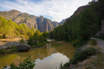 Fototapeta na wymiar Mountains of Beseit where the Ulldemó river runs on the route of La Pesquera in Beceite, Matarraña. Aragon, Spain.