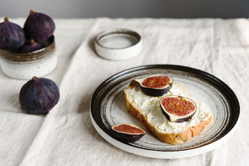 Sandwich with Ricotta and fresh Figs on natural linen tablecloth. Simple healthy breakfast
