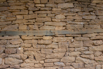 old stone wall with wooden beams