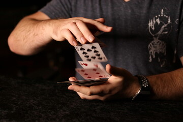 card magician practicing sleight of hand magic Cardestry