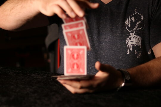 Card Magician Practicing Sleight Of Hand Magic
