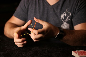 close up of a magician practicing a rubberband trick