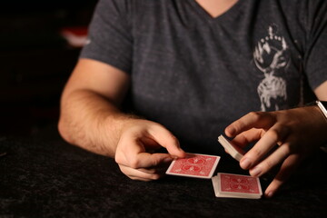 card magician practicing sleight of hand magic