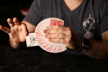 card magician practicing sleight of hand magic