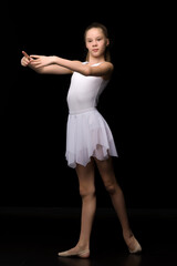 Full length portrait of a charming gymnast girl in elegant dress.