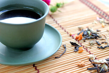 healthy green tea cup with tea leaves and flowers