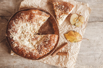 Sliced homemade apple pie on vintage wooden background texture. Top view. Copy, empty space for text