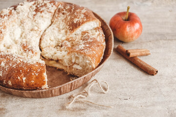 Sliced homemade apple pie on vintage wooden background texture. Copy, empty space for text