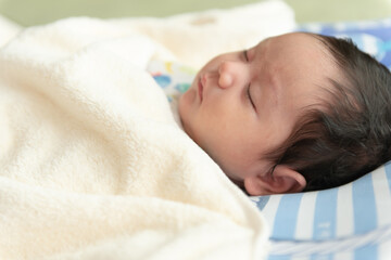 Obraz na płótnie Canvas Close up of sleeping Asian baby girl