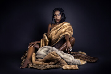 A portrait of a serene young black female with long dreadlocks, beautiful makeup and perfect lips...