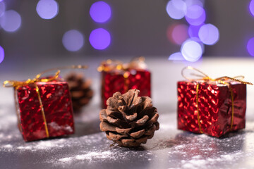 Christmas decorations in the snow - gifts and cones. Christmas mood. 
