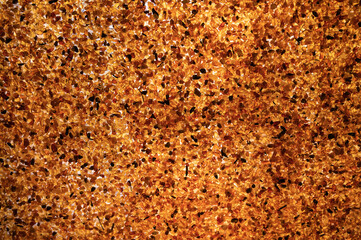 Mosaic of amber stones in contour sunlight as background, close up, selective focus