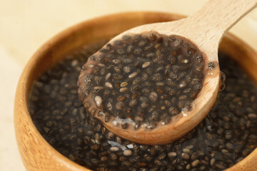 Close-up of chia gel in wooden bowl with a spoon