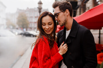 Beautiful couple in love hugging and flirting outdoor. Romantic moments. Handsome man looking on...