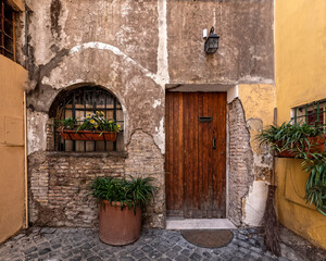 Fototapeta na wymiar Rome Italy, picturesque house front with natural wood door and window
