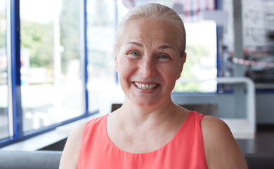 Happy beautiful middle aged woman in cafe