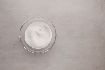 Collagen powder in bowl on stone background. Extra protein intake. Natural beauty and health supplement for skin, bones, joints and gut. Plant or fish based. Flat lay, top view, copy space