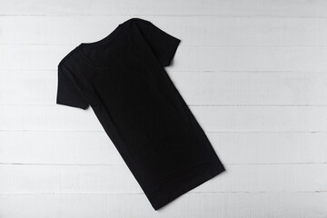 Black knitted t-shirt without pattern on white background. Clothing unisex. Mockup
