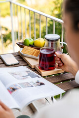 woman wrapped in blanket drinking hot brewed red tea. Tea for immunity, ingredients for the treatment of colds.