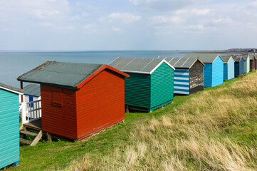Fototapeta na wymiar Traditional colorful English beach huts in Whitstable, Kent in the United Kingdom