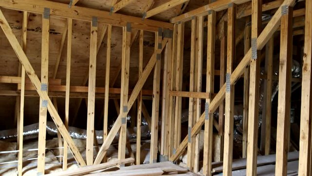 House attic under construction interior inside a frame walls and ceiling material in wooden frame