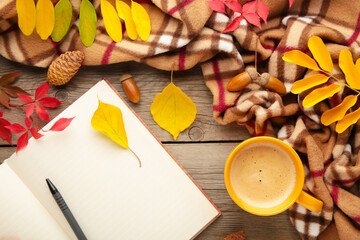 Autumn composition. Cup of coffee, gift, dried autumn leaves, croissant on grey background. Flat lay, top view, copy space
