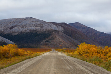 View of Scenic Road and Mountains on a Fall Day in Canadian Nature. Taken near Tombstone Territorial Park, Yukon, Canada.