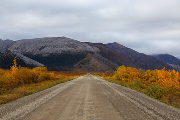 View of Scenic Road and Mountains on a Fall Day in Canadian Nature. Taken near Tombstone Territorial Park, Yukon, Canada.