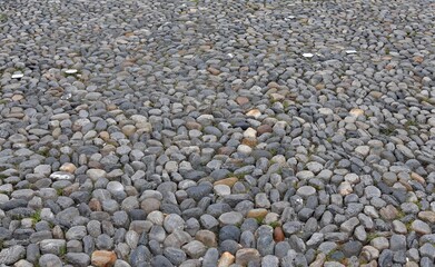 Pavement of the Piazza Grande, main square in the city center of Locarno, a city in Italian speaking canton in Switzerland. The round stones are cemented together. 