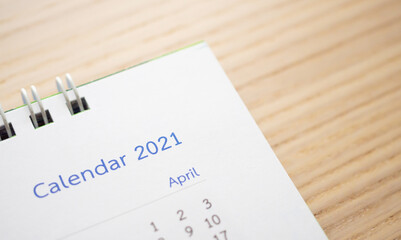 calendar page 2021 close up on wood table background business planning appointment meeting concept