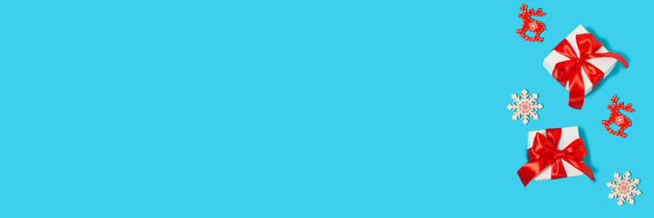 Merry Christmas and Happy Holidays postcard, frame, banner. New Year. Gift boxes on a light blue background with Christmas decorations. Winter holiday theme. Flat lay