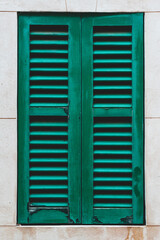 Window of a house with green shutters