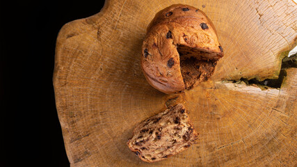 Panettone with chocolate chips on rustic wood, top view