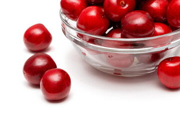 fresh black cherries in a glass plate on a white background