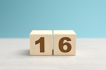 Wooden toy blocks forming the number 16.