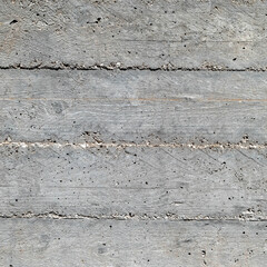 grey concrete wall closeup with wooden planks pattern imprint, seamless background
