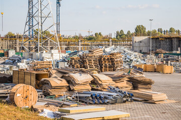 Construction site of shopping mall with cranes, wooden pallets and construction materials Kyiv. Obolon