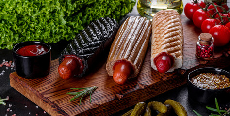 Delicious fresh hot hotdogs with various kinds of buns and sausages.