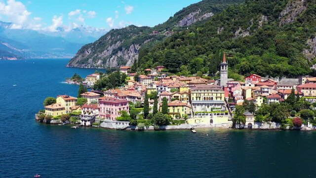 Village by the Lake Como in Italy. Aerial view with a drone of the beautiful small village under the blue sky 4K