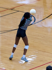 Fototapeta premium Young girl playing in a competitive volleyball match